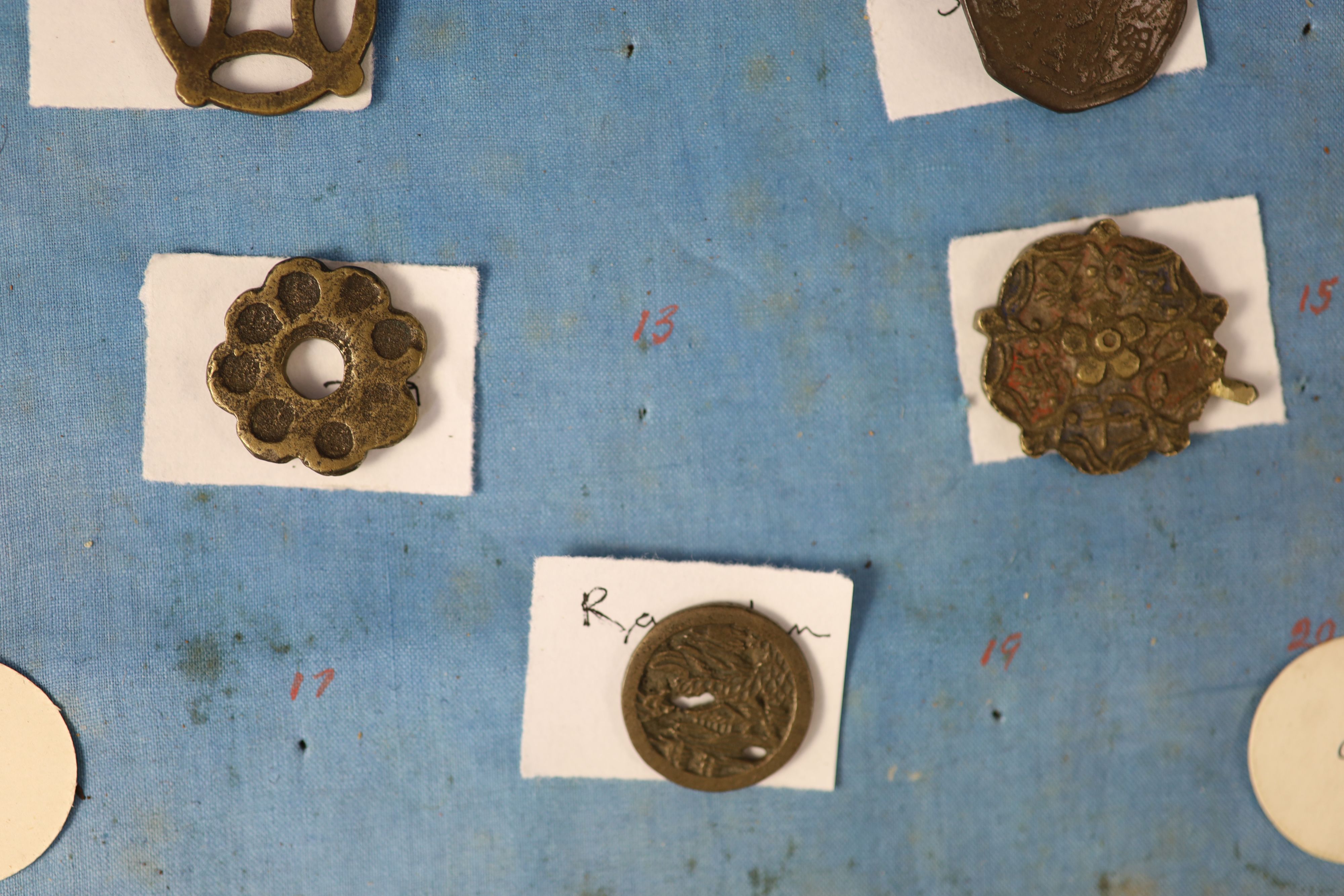 A group of 99 Korean bronze and metal amulets or charms, 19th/20th century